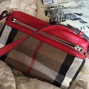 This Authentic BURBERRY Canvas Clutch/ Crossbody bag is new..